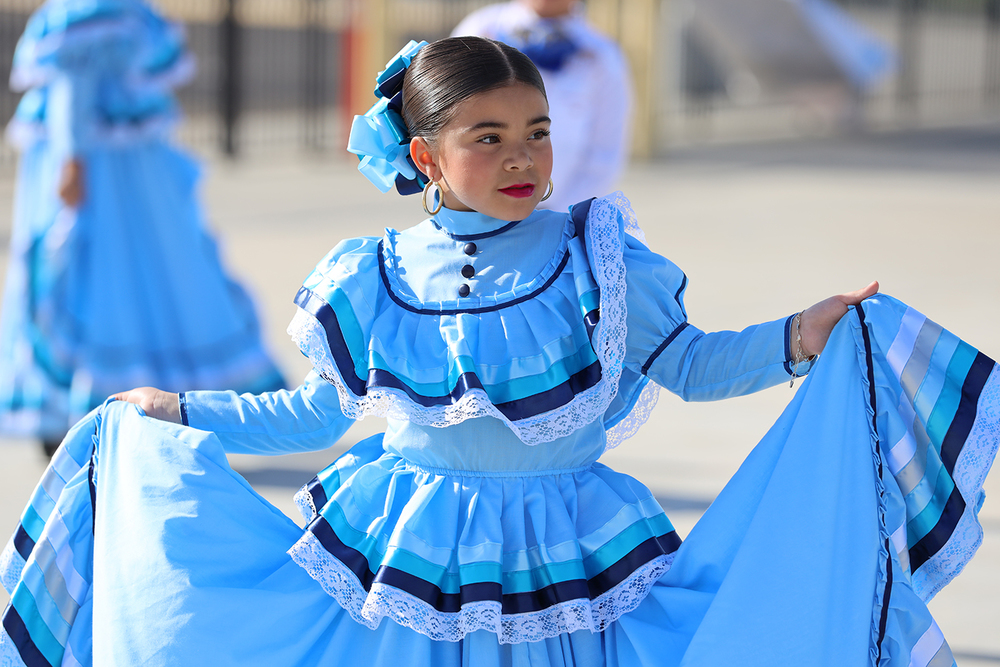 Little girl dancing in blue dress