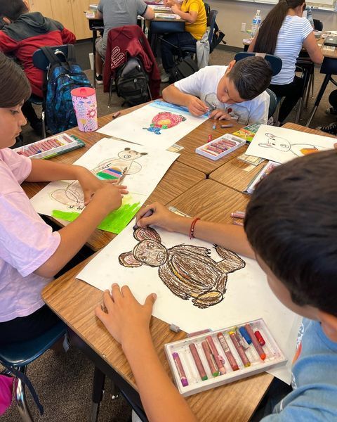 students in art class drawing animals 