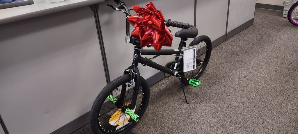 black bicycle with red ribbon