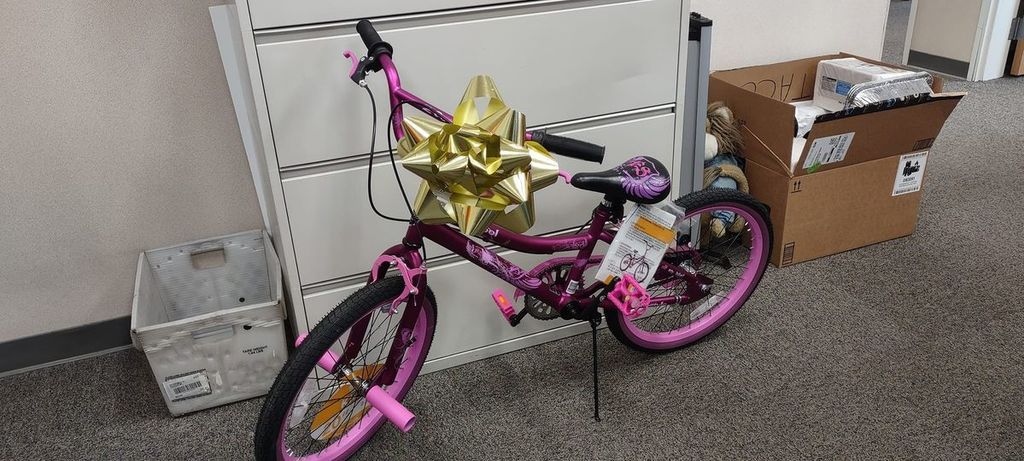 pink bicycle with gold ribbon