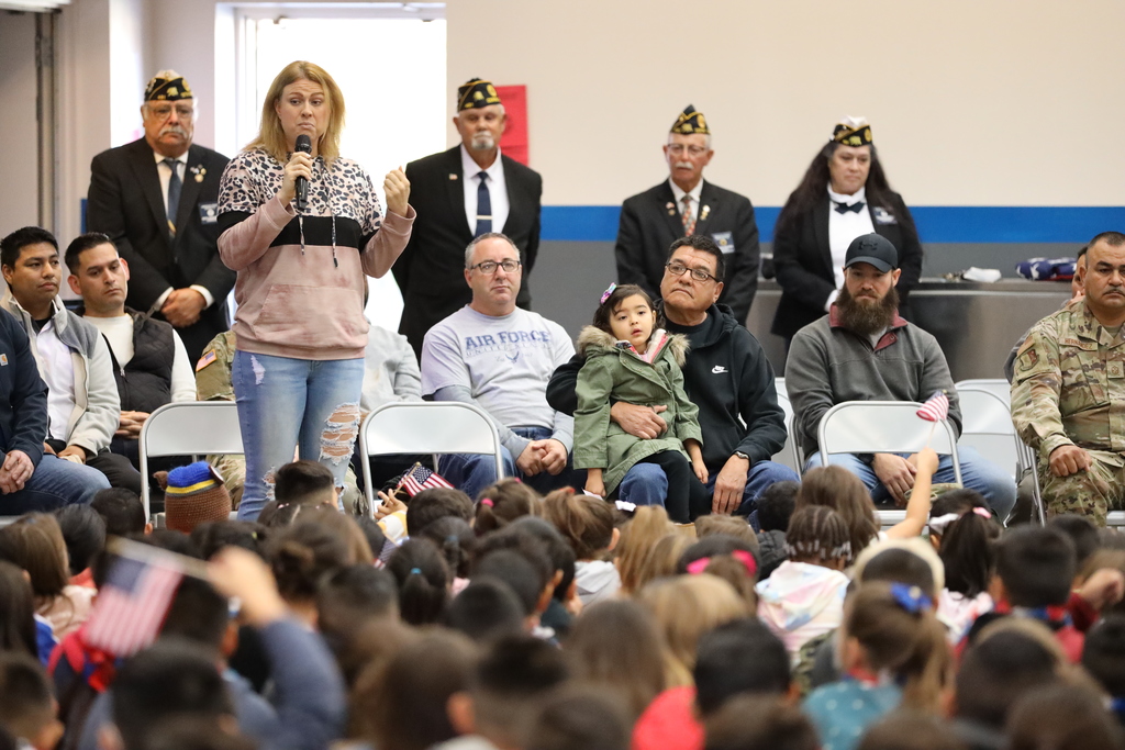 Woman addresses students at veterans tribute