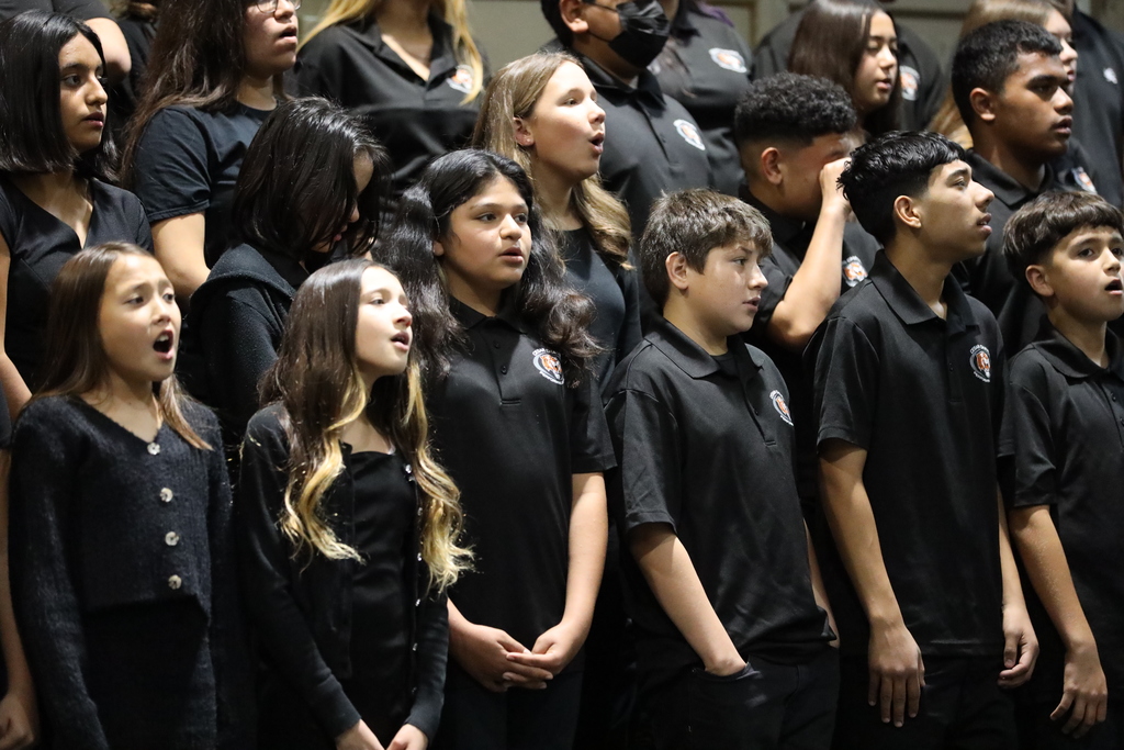 Junior high school dressed in black perform at Singsational
