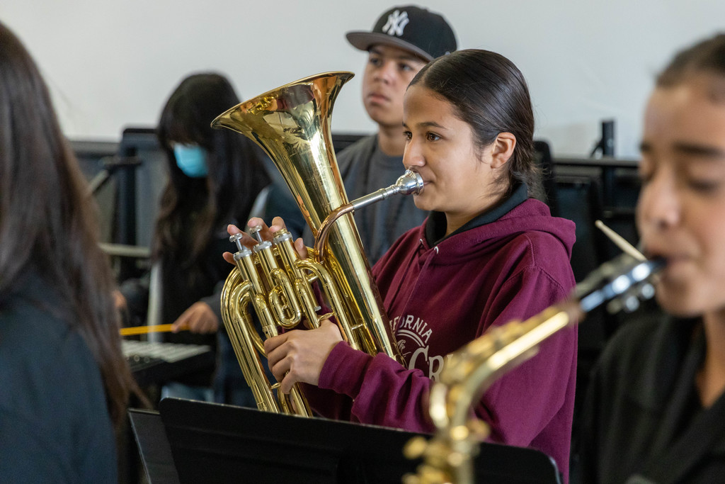 Junior high school band students play brass instruments