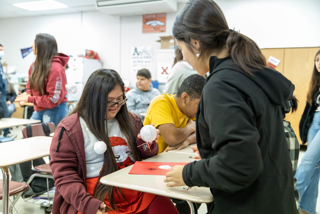 Two female students admire holiday craft