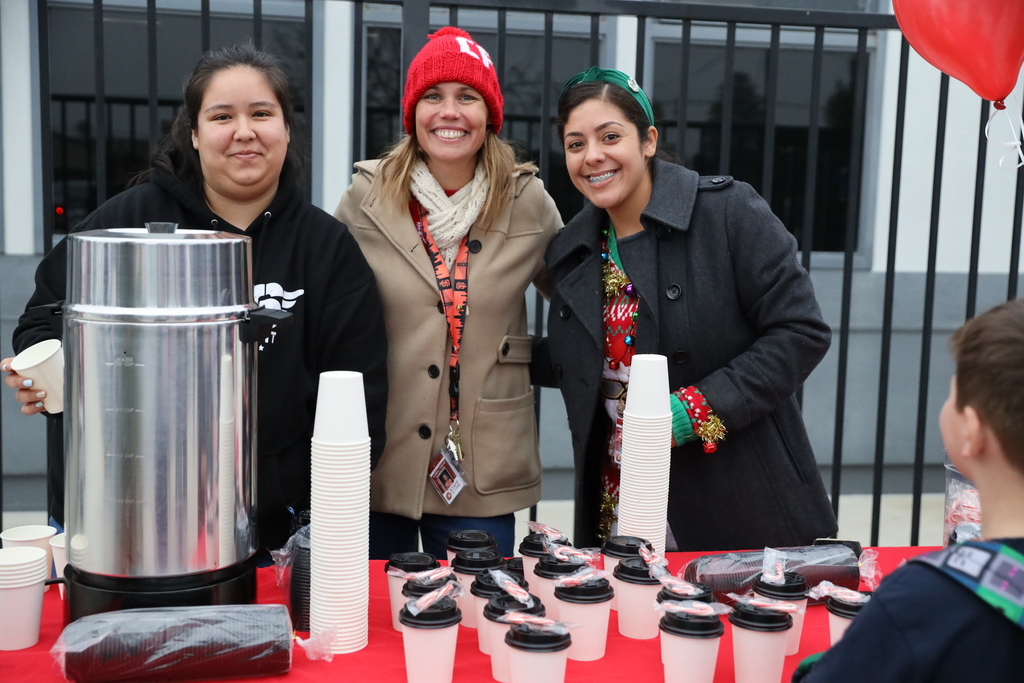 Three Carroll Fowler staff members serve hot cocoa and smiles