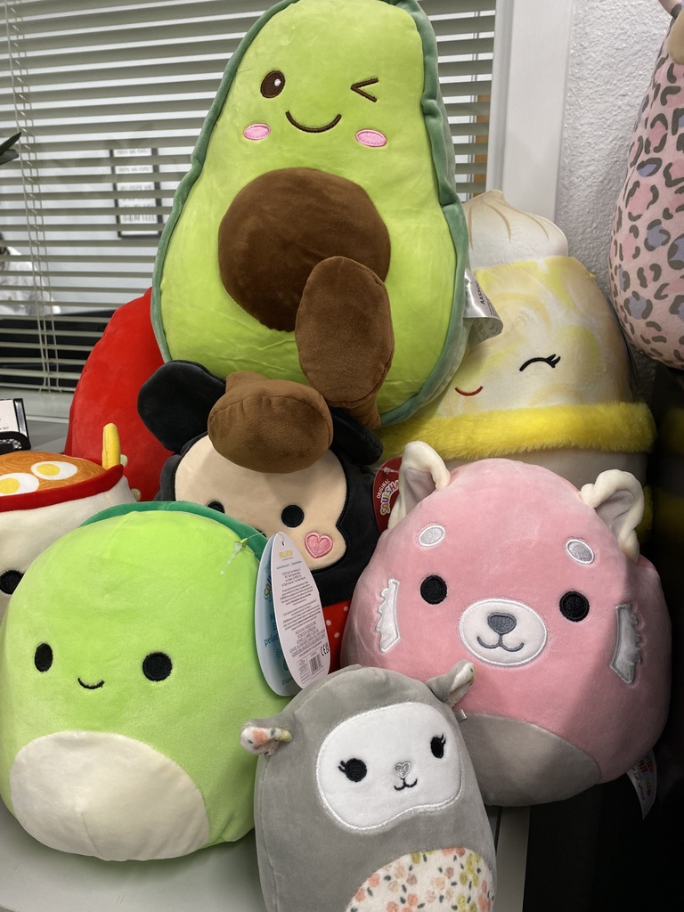 Squishmallows including an avocado, Mickey Mouse, and a lamb