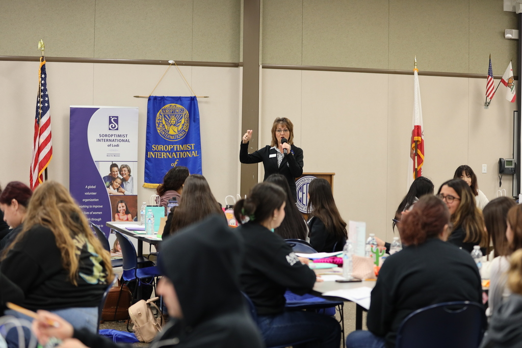 Denise Wickham presents to room crowded with high school girls
