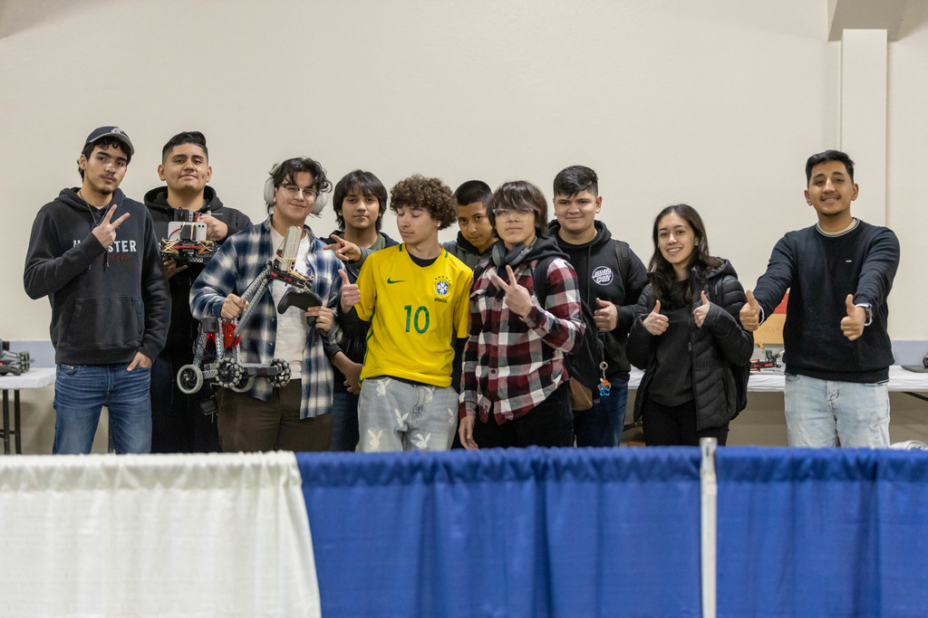 Group of students holding robot
