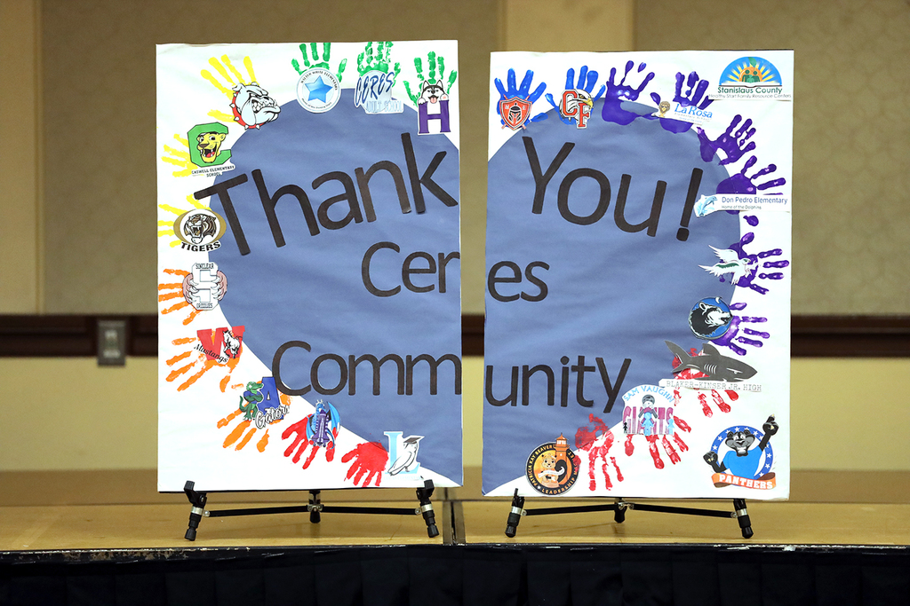 Poster with heart shape and handprints, reads Thank You Ceres Community