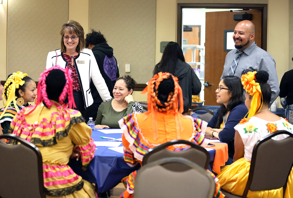 Superintendent Wickham and Mayor Lopez chat with folklorico dancers