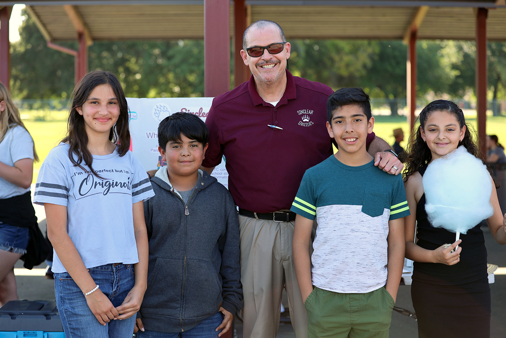Sinclear administrator with four students at open house