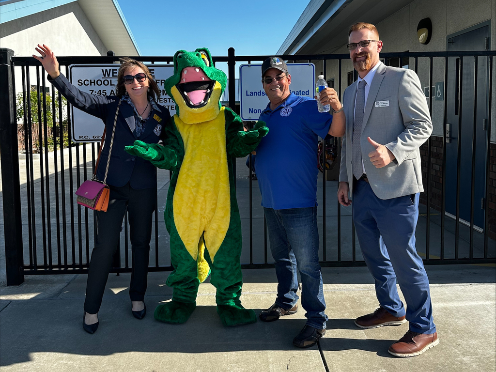 District leaders with Adkison mascot in front of school
