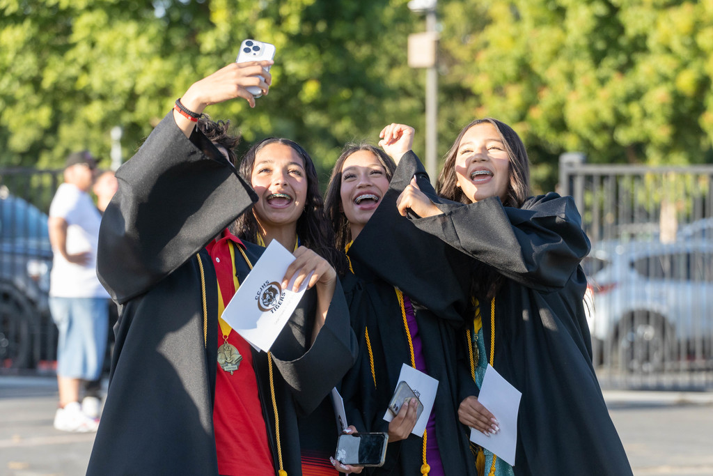 Female Chavez Junior High students take celebratory selfie after promotion ceremony