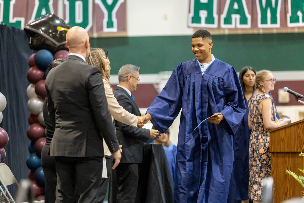 Whitmore Charter High School student crosses stage, shakes hands with Assistant Principal