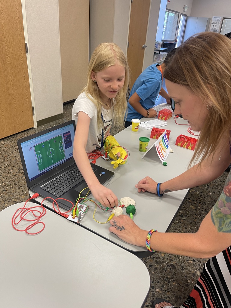 Student shows parent how to use objects as conductors