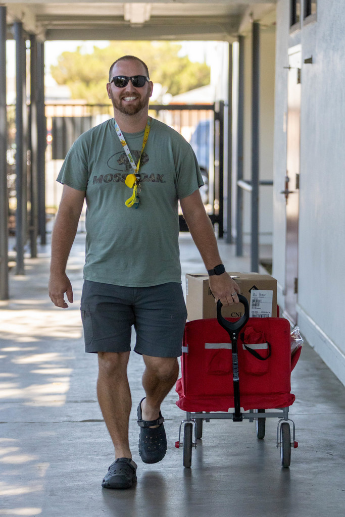 Employee pulls red cart