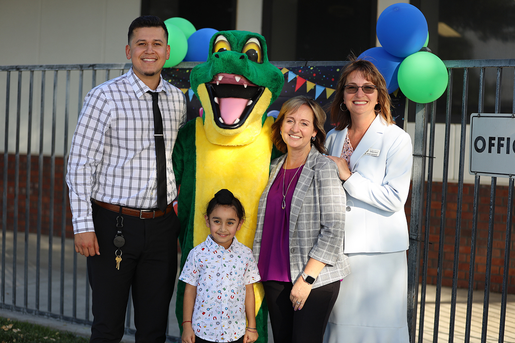 Adkison Gator with staff and student