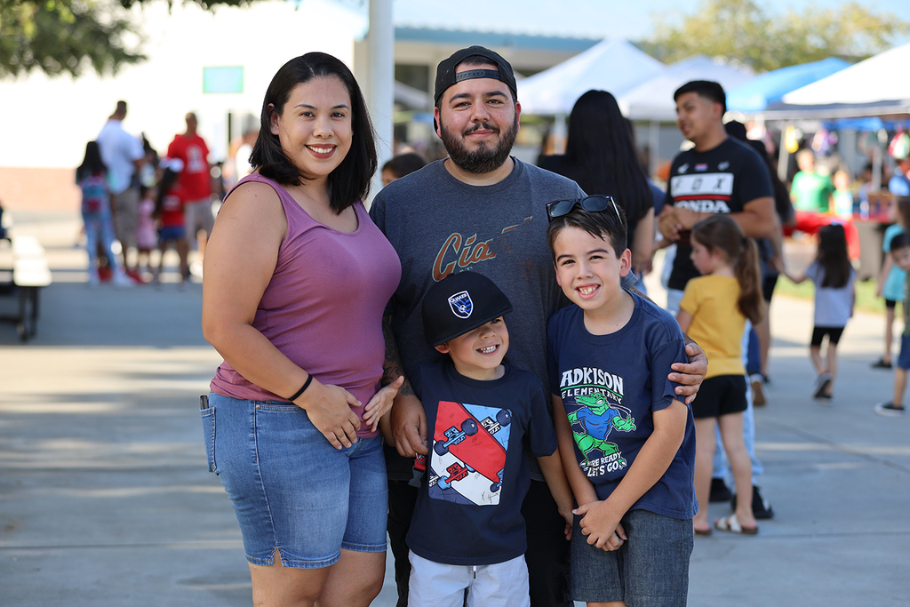 Family of four smiles at Adkison Back to School night