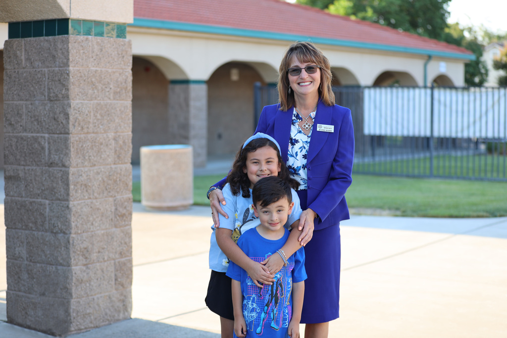 Smiling superintendent and students at Sam Vaughn Elementary