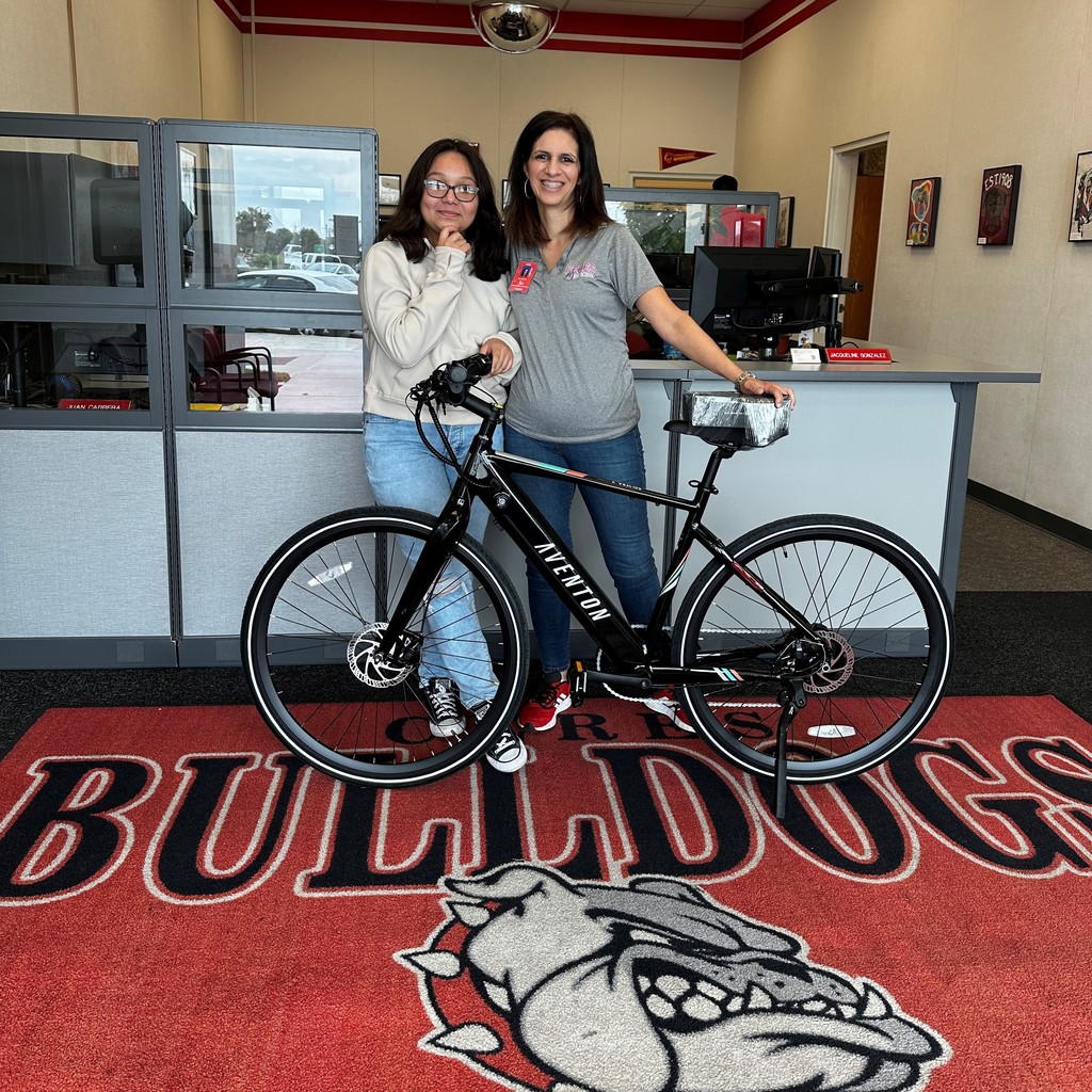Principal with winning student and bike