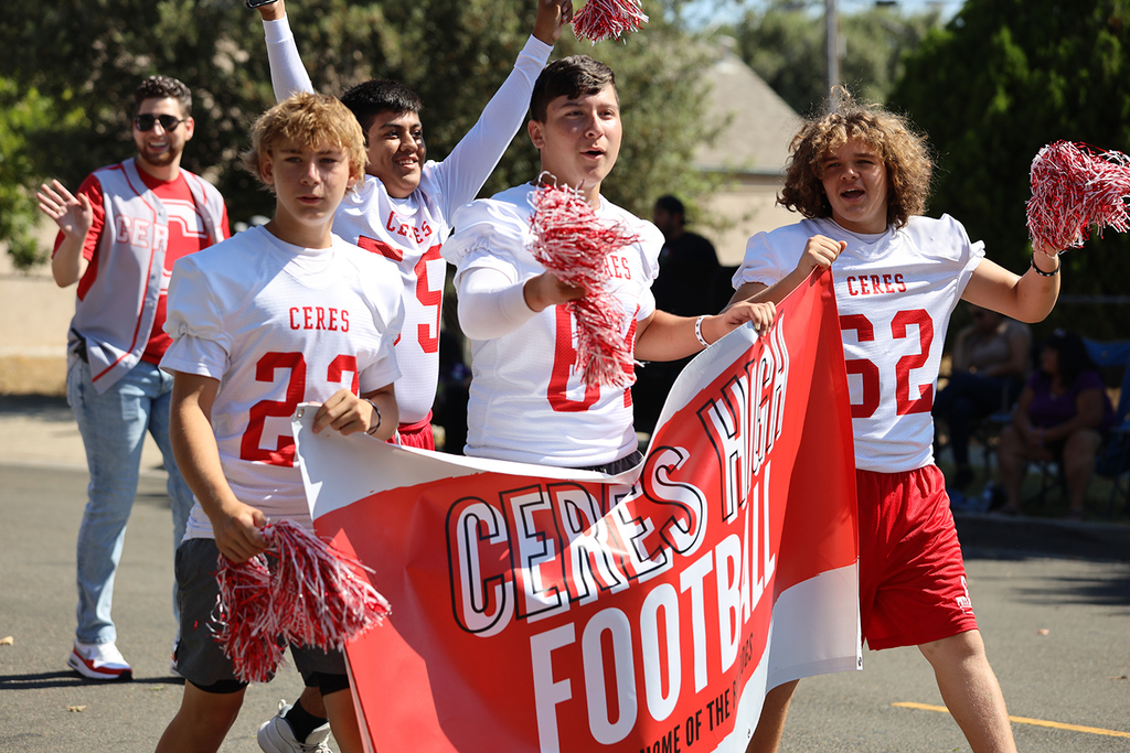 Ceres HS football players waving pompoms, holding banner