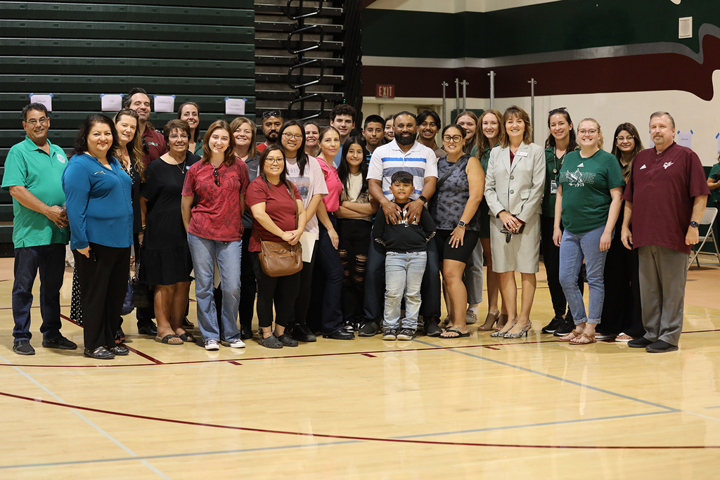 Group of teachers, administrators, students, and Board members in CVHS Gym