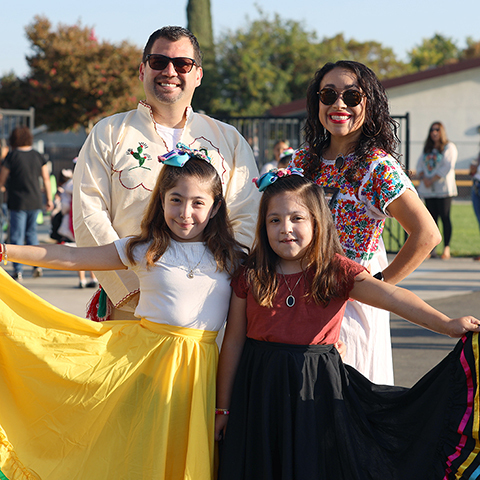 Mr. Maldonado, Ms. Marshall, and students in colorful skirts