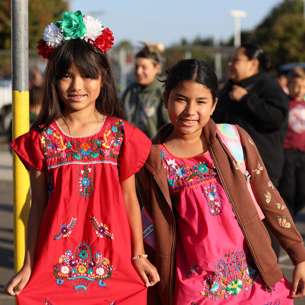 Two girls in colorful embroidered dresses