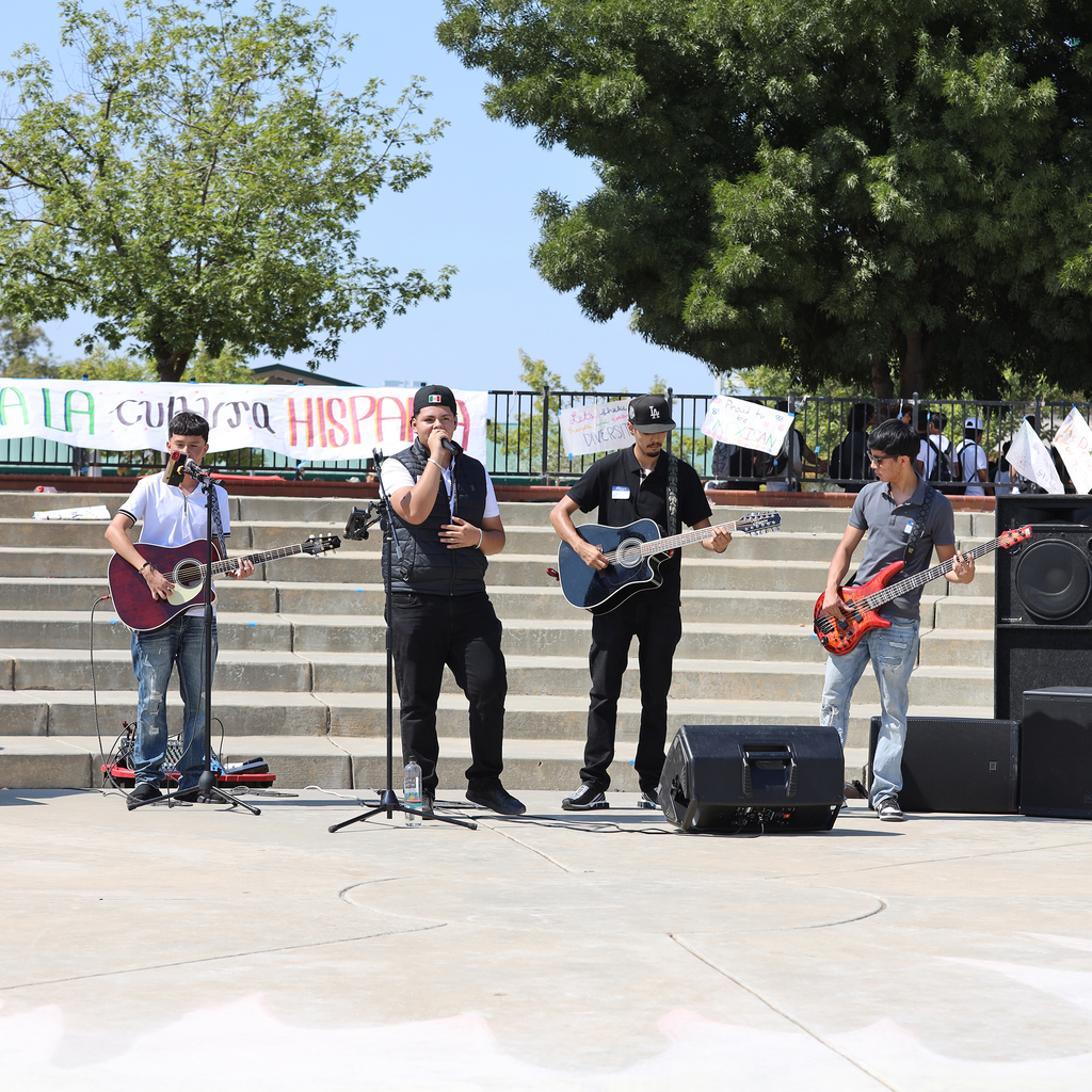 Singer and three guitar players perform